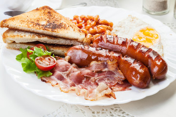 Full English breakfast with bacon, sausage, egg and beans