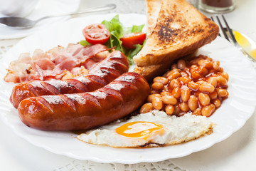 Full English breakfast with bacon, sausage, egg and beans