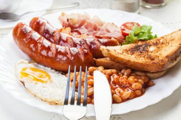 Full English breakfast with bacon, sausage, egg and beans