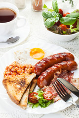Full English breakfast with bacon, sausage, egg and beans