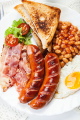 Full English breakfast with bacon, sausage, egg and beans
