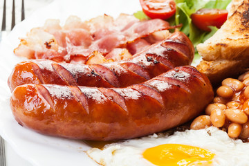 Full English breakfast with bacon, sausage, egg and beans