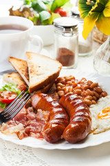 Full English breakfast with bacon, sausage, egg and beans