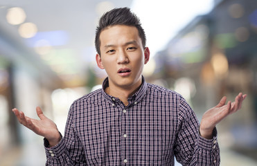 portrait of handsome young asian man dobting