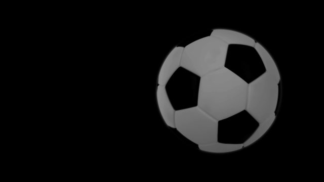 Soccer ball flies at the camera then stops but keeps rotating.