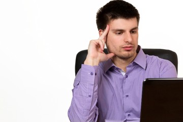 Young handsome businessman working on laptop