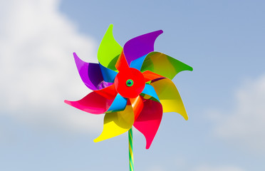 Childish pinwheel against blue sky background.