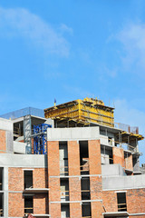 Building construction site work against blue sky
