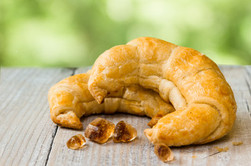 Two croissant on wooden background