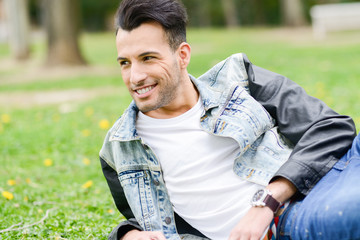 Fototapeta premium Attractive young handsome man, model of fashion in urban backgro
