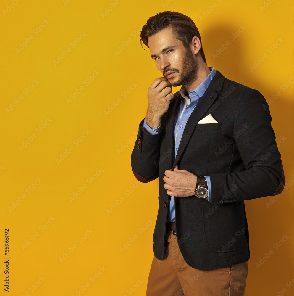 Wall mural Handsome man on yellow background