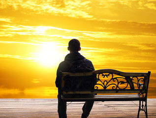 The lonely man sits on a decline
