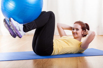 Girl exercising with gym ball