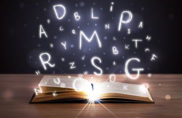 Open book with glowing letters flying out
