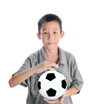 Cute Asian boy playing football, happy child, isolated on white.