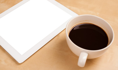 Obraz na płótnie Canvas Tablet pc with empty space and a cup of coffee on a desk