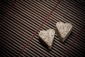 two sugar hearts on wooden texture - 65970557