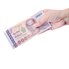 Hand holding Thai money isolated on white.