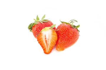 Three fresh strawberries and a slice