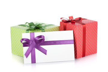 Colorful gift boxes and letter with ribbon and bow