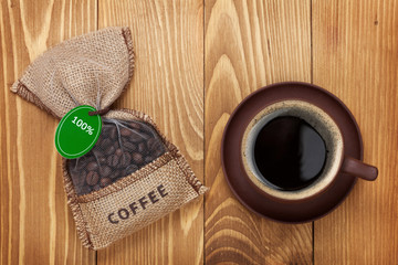 Coffee cup and small bag with beans