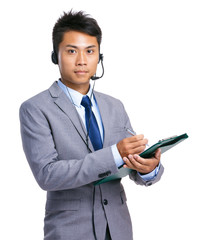 Businessman hold clipboard with headset