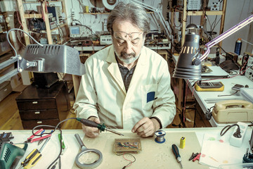electronic engineer in the laboratory with a soldering iron