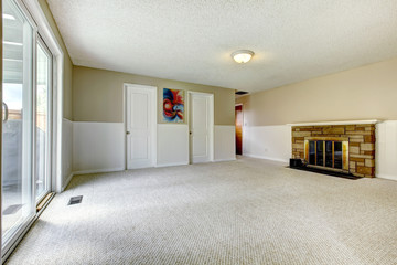 Empty room with fireplace and walkout deck