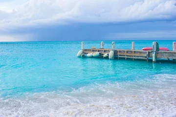 Papier Peint photo autocollant Île Perfect beach with pier at caribbean island in Turks and Caicos