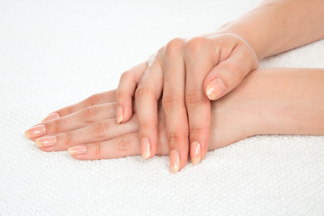 Beautiful woman hands with french manicure nails
