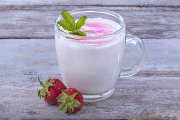 Fresh yogurt with strawberries on a rustic table
