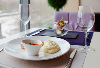 Cutlets, potato mash and vegetable salad on restaurant table