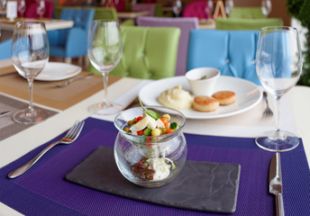 Cutlets, potato mash and vegetable salad on restaurant table