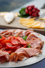 Platter with cured ham on table
