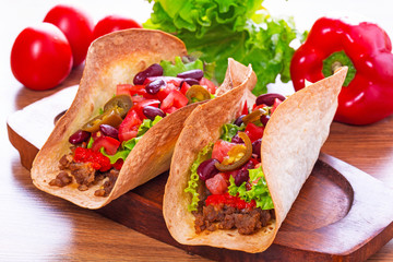 Mexican tacos in tortilla shells with fresh vegetables
