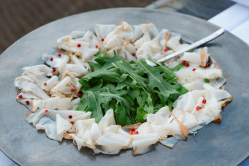 Thin sliced lard on old metal plate