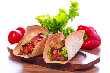 Mexican tacos in tortilla shells with fresh vegetables