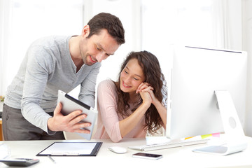 Man working on tablet with his co-worker