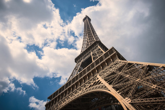 Eiffel Tower isolated against blue cloudy sky. Paris, France.