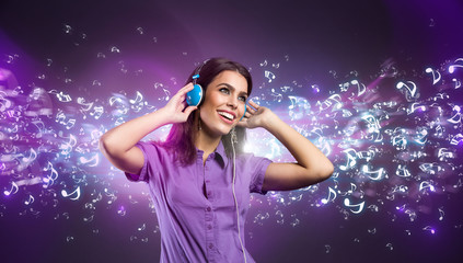 Pretty young woman with headphones listening to music