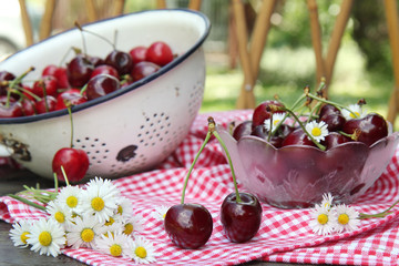 Sweet cherries on a wooden table in the garden
