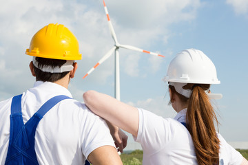 Engineers or installers looking at wind energy turbine