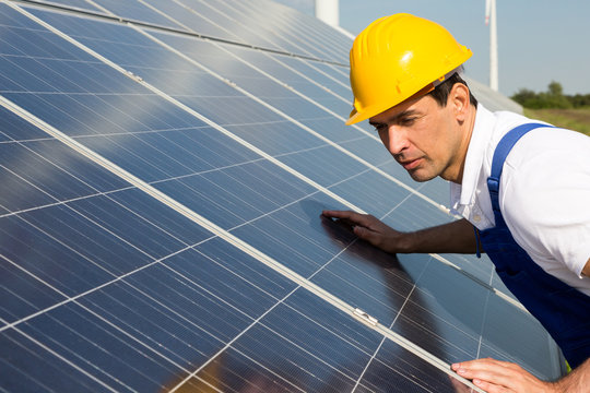 Engineer or installer inspecting solar energy panels