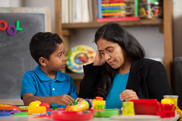 Fototapeta na wymiar Hispanic Mom with Child in Home School Setting Working on Crafts