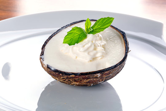 Coconut ice cream in coco shell on the plate