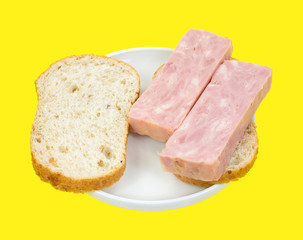 Processed ham sandwich on yellow background