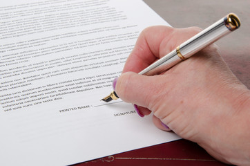 Hand signing a paper