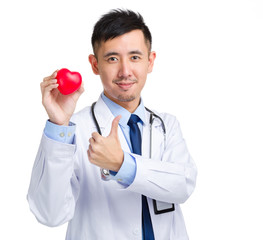 Male doctor with red heart and thumb up