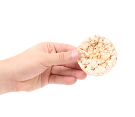 Puffed rice snack in hand.