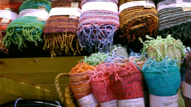 The colored rolled scarves in rows at market. Video shift motion